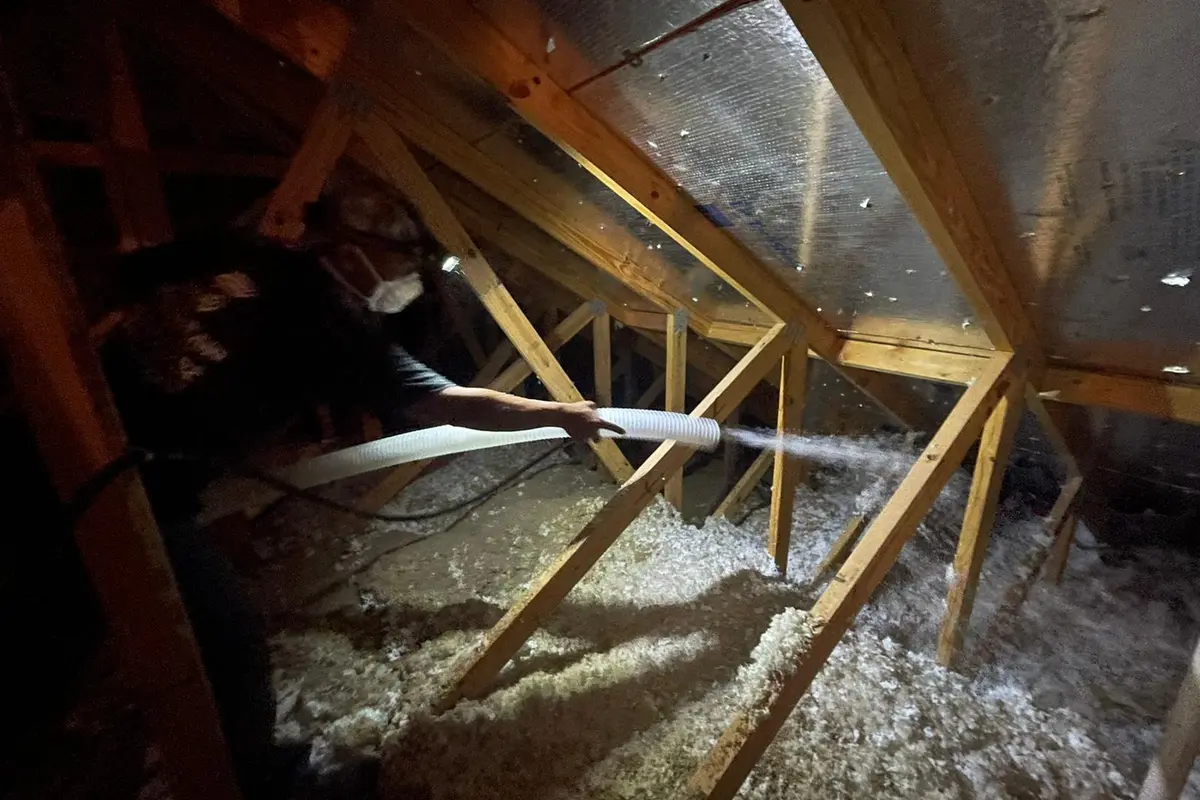 Blown-in insulation being installed in Austin home attic