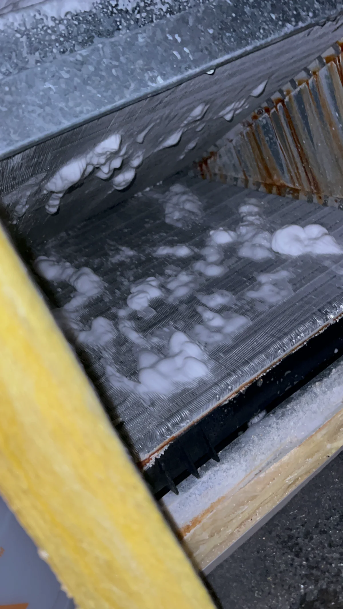 Evaporator coil cleaning with professional foam treatment during HVAC maintenance